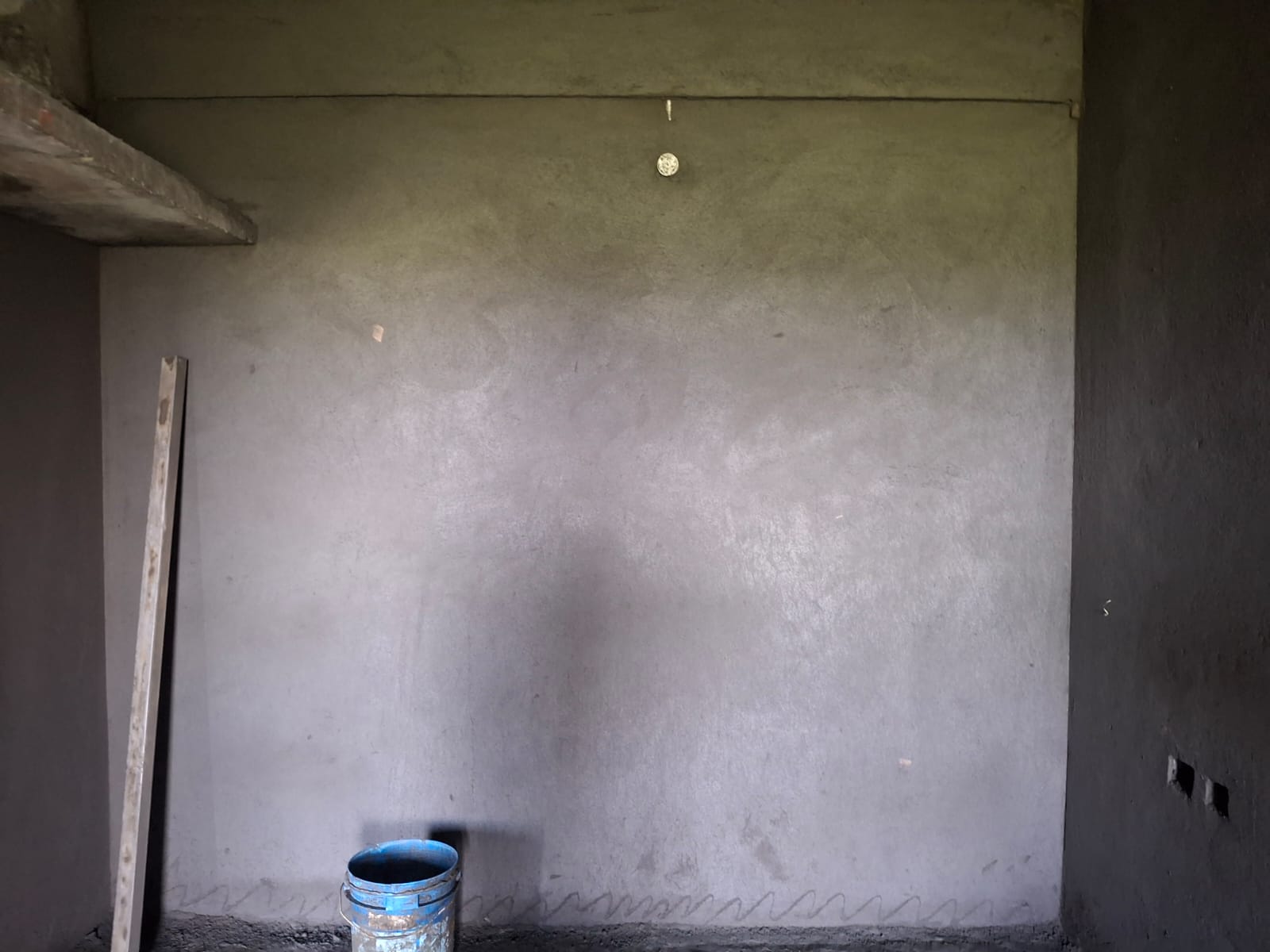 Digger working on a concrete foundation for a building